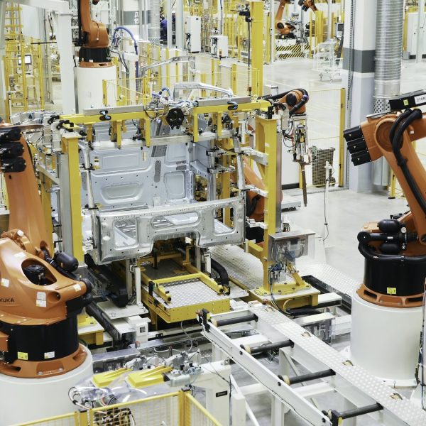 Latest technology in machine production. Scene. Robotic machines working in production of cars and